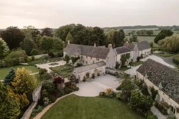 Charming rustic cottages nestled in lush gardens, surrounded by rolling hills, create a picturesque setting for intimate weddings.