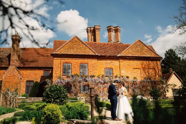 Charming brick manor surrounded by vibrant gardens, perfect for outdoor ceremonies and intimate celebrations. A picturesque rural setting.