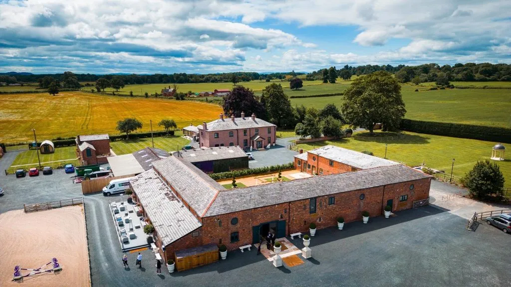 Charming rustic barn venue surrounded by lush countryside, ideal for picturesque outdoor ceremonies and celebrations.