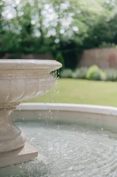 White stone water fountain in centre of English Walled Garden by Katie Buffey