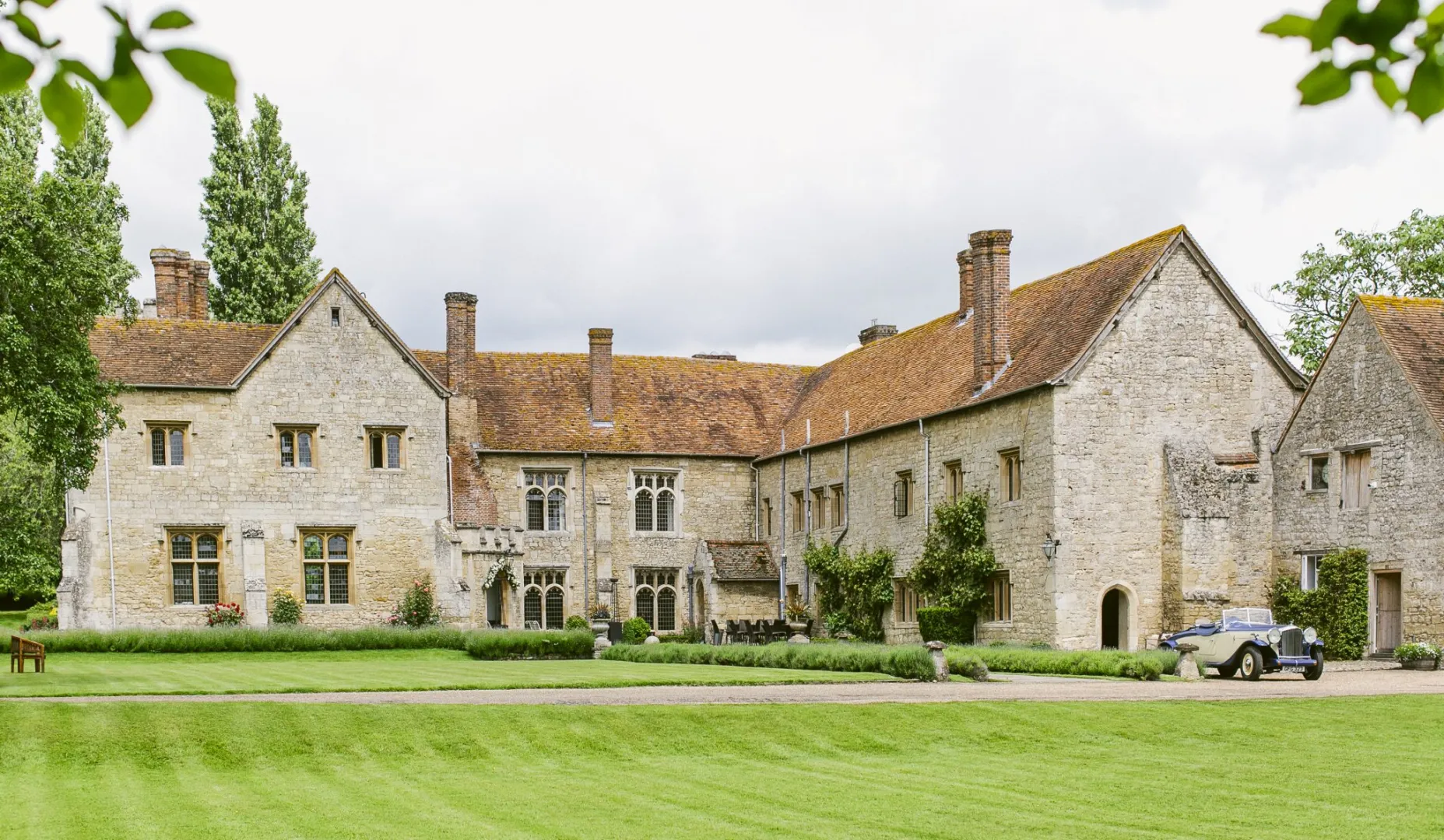 Historic stone mansion surrounded by lush green lawns, offering a picturesque backdrop for outdoor ceremonies and elegant receptions.