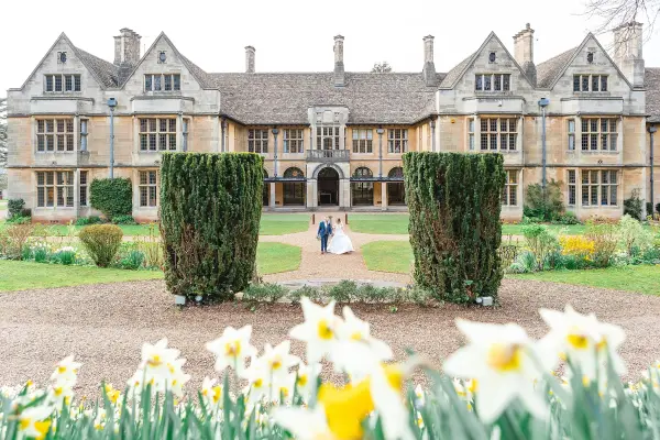 Elegant historic mansion surrounded by manicured gardens and blooming daffodils, perfect for outdoor wedding ceremonies.